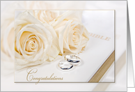 newlywed congratulations, white roses with wedding rings on Holy Bible card